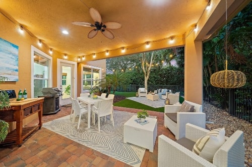 backyard patio with lights and updated furniture designed to create an outdoor experience