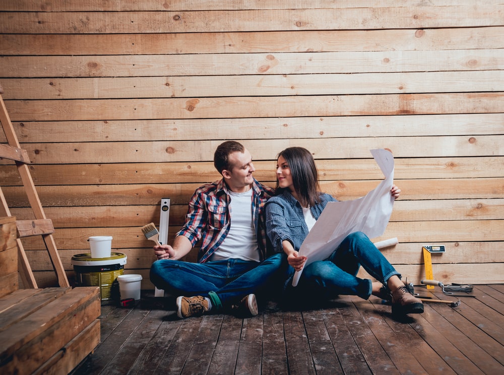 couple sitting on the floor with home renovation plans