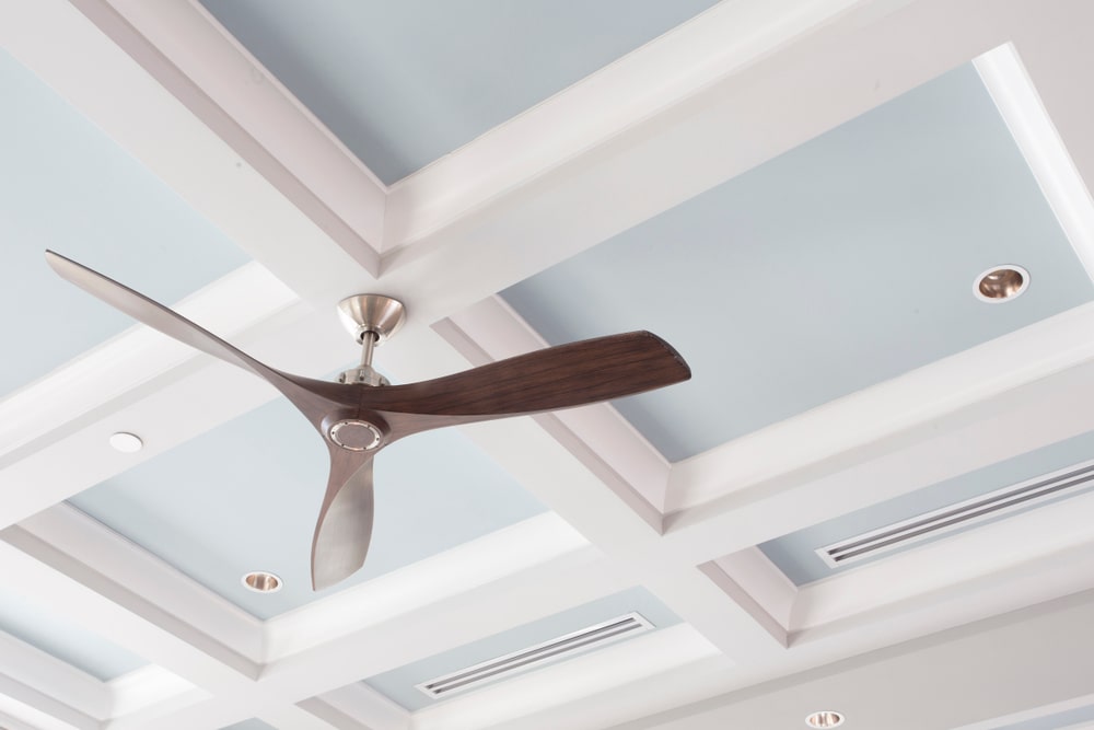 3 blade ceiling fan installed on a blue and white ceiling, added to increase value of a home