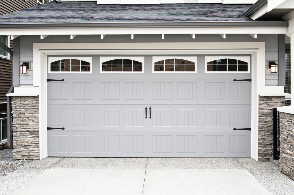 upgraded painted light blue garage door with white trim and 4 small windows