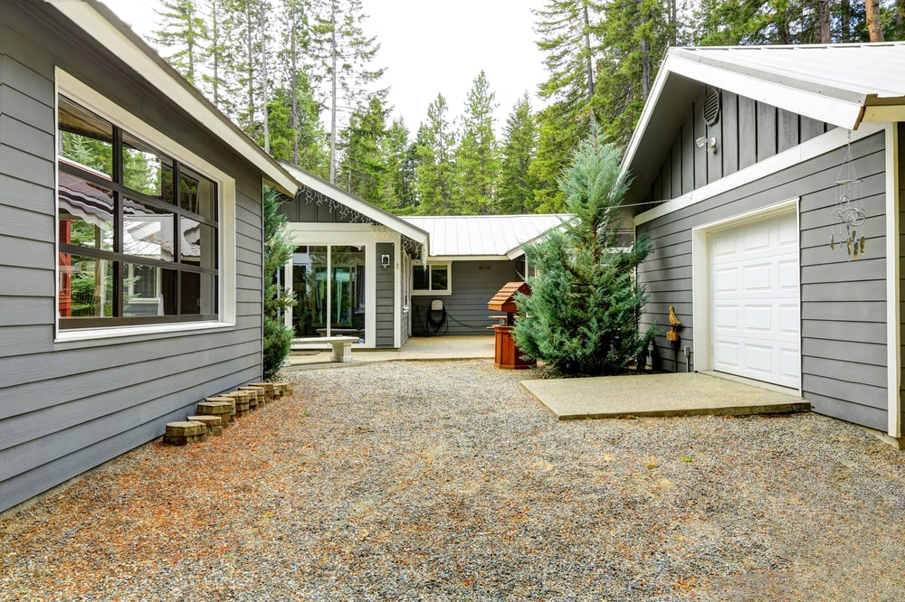 gray house with white trim with an added detached garage for added value