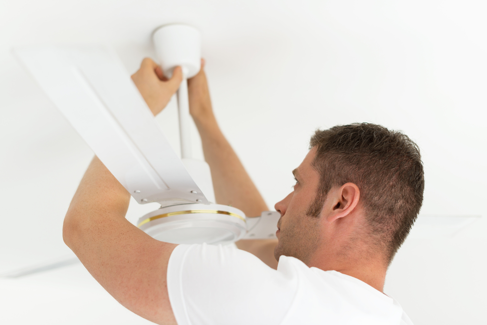 handyperson installing a white ceiling fan