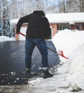 man shoveling driveway